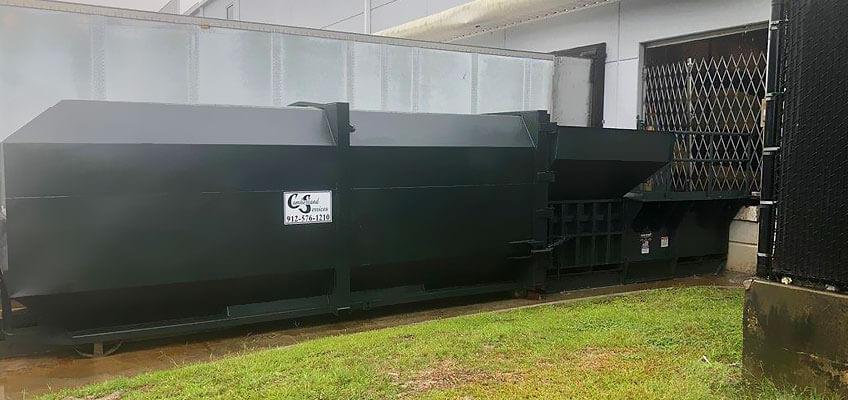 Cumberland Services LLC compactor with integrated loader